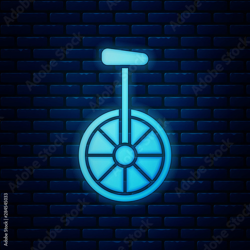 Glowing neon Unicycle or one wheel bicycle icon isolated on brick wall background. Monowheel bicycle. Vector Illustration