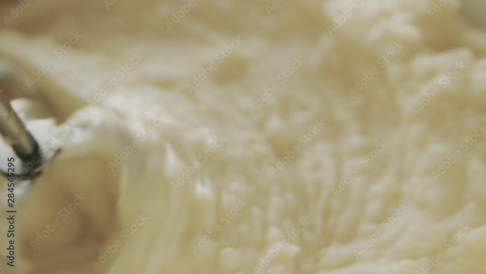 Closeup, macro. Mixed and creamy mashed potato with milk and butter. Mixer whips up and shake up mass. Fresh hot cooked food at home or restaurant. Crushing Boiled Potatoes Closeup, macro. Mixed and creamy mashed potato with milk and butter. Mixer whips up and shake up mass. Fresh hot cooked food at home or restaurant. Crushing Boiled Potatoes