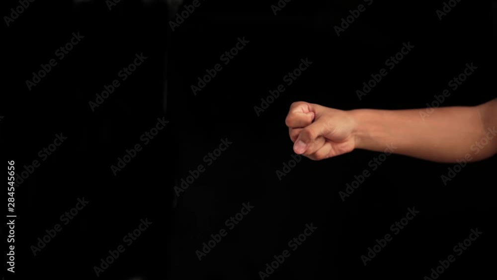 Human hand of caucasian white isolated on black coming up and showing Q