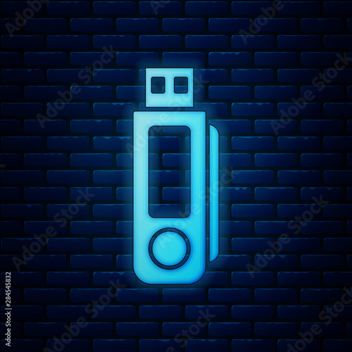 Glowing neon USB flash drive icon isolated on brick wall background. Vector Illustration