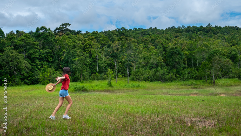 Young asia woman in a green field,enjoying in the sunny summer day. Young asia woman in a green field,enjoying in the sunny summer day.