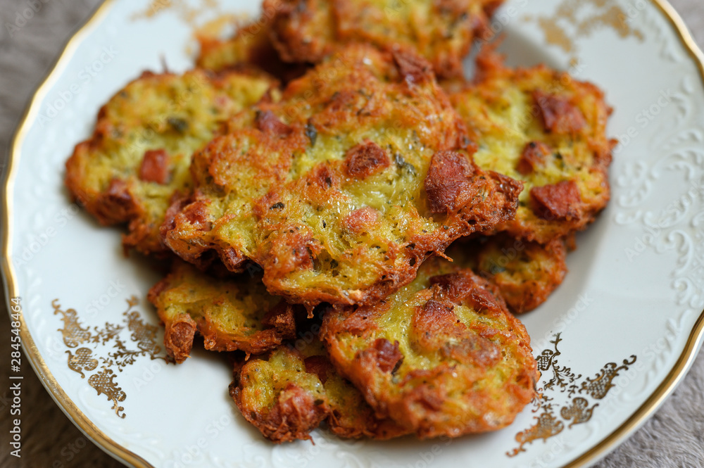 Potato pancakes with sausage on a ceramic plate. Potato pancakes with sausage on a ceramic plate.