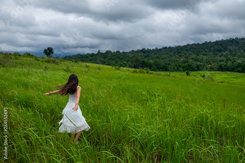 Wallpaper Mural Girl with white dress running in a green field,enjoying in the sunny summer day Torontodigital.ca