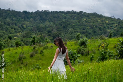 Wallpaper Mural Girl with white dress in a green field,enjoying in the sunny summer day Torontodigital.ca