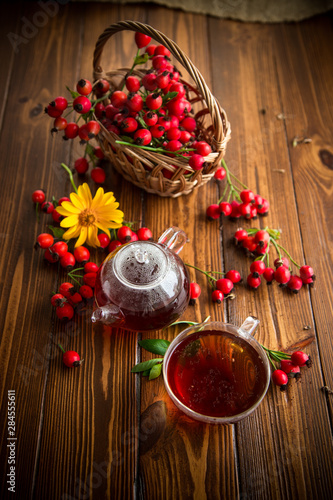 Fototapeta Naklejka Na Ścianę i Meble -  hot tea from medicinal fruits of red ripe rosehip