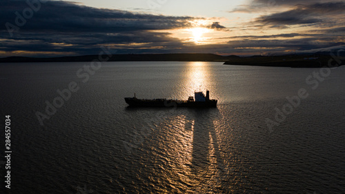 The sea vessel against the background of a sunset. © Valerii