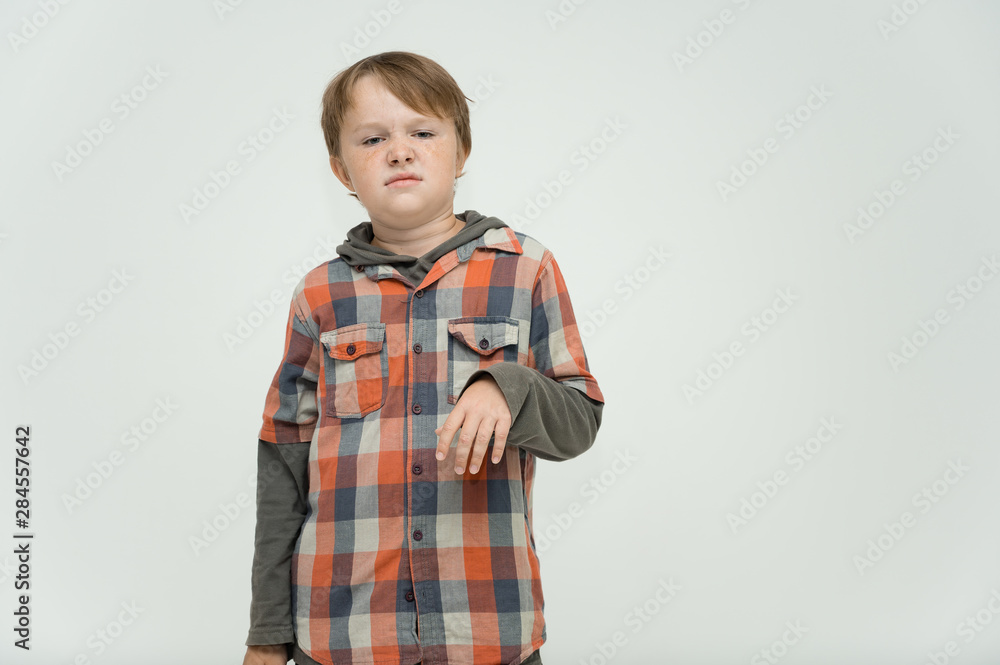 Photo portrait waist-high of a fun cheerful cute happy school-age boy. Rejoices, smiles on a white background. Shows hands. Photo portrait waist-high of a fun cheerful cute happy school-age boy. Rejoices, smiles on a white background. Shows hands.