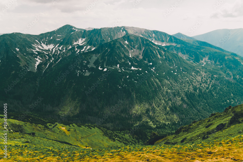 Beautiful panorama of green mountains hills with snow from Kars to Kasprowy Wierch in summer.