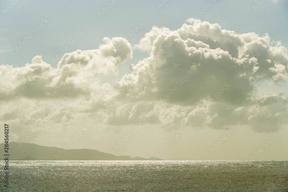 Obraz premium Blue sky with clouds over sea water. Nature composition.