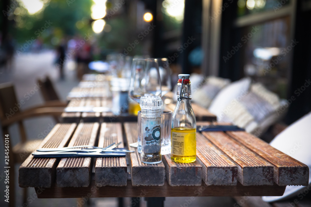 Cafe outdoor table setting with glasses and condiments Cafe outdoor table setting with glasses and condiments