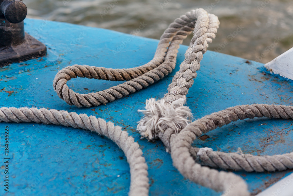 Fototapeta premium Old rope lies on board ship close-up