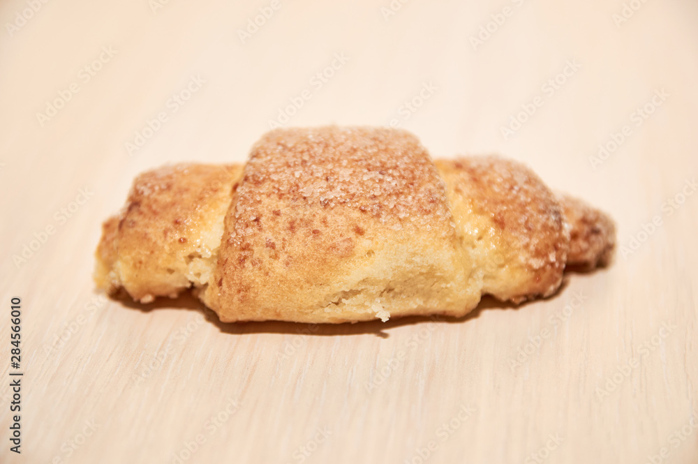 freshly baked croissants on a light wooden table