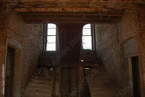 stairs and windows of an abandoned house
