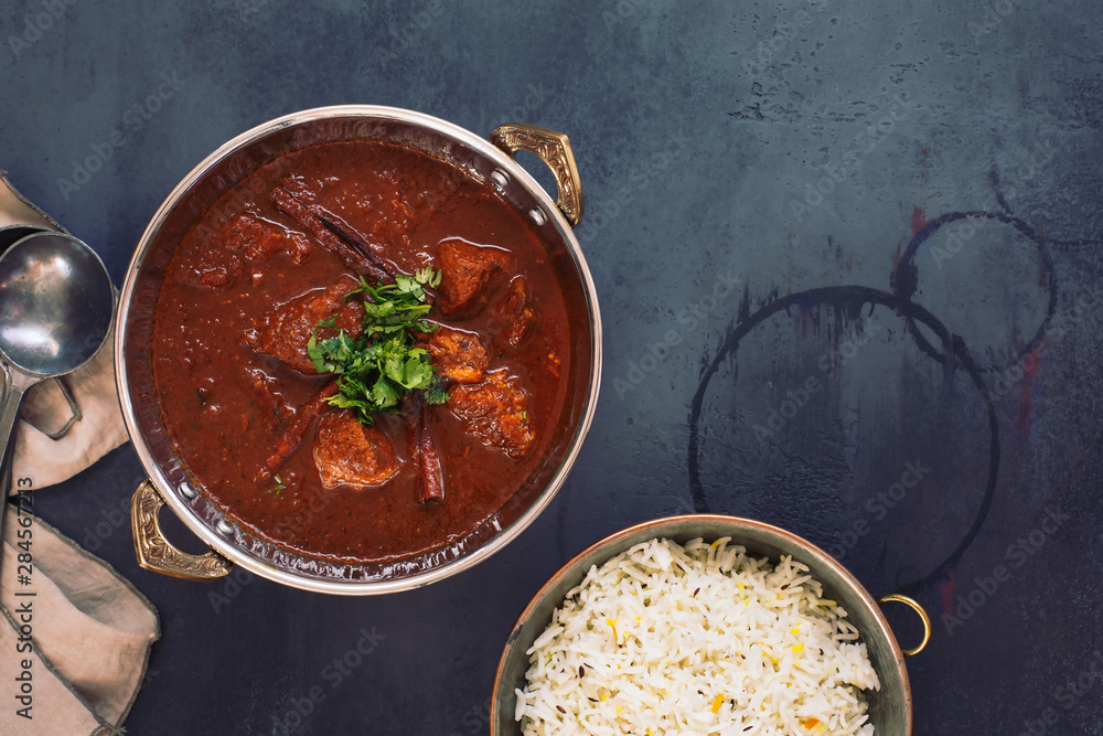 Kashmiri Lamb Rogan Josh. Slow cooked lamb curry served with pulao rice and garnished with