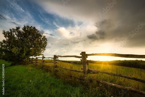 Fence on a sunny pasture photo