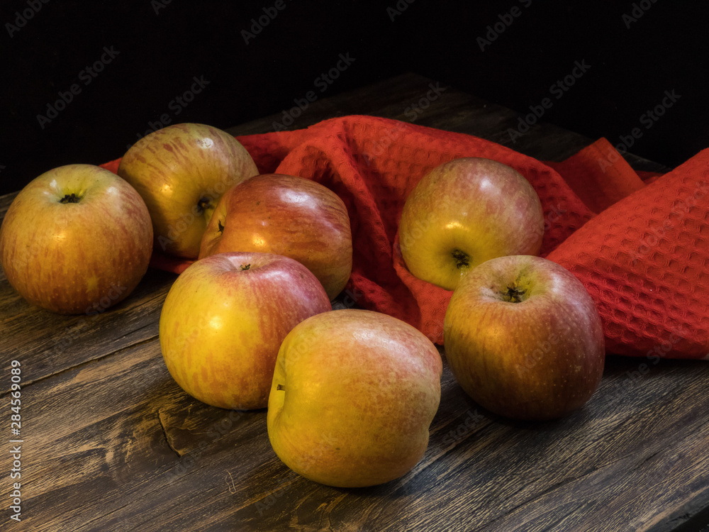 Apples on the dark wooden table, black background Apples on the dark wooden table, black background