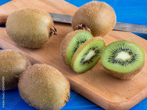 Fresh kiwi fruits   on the blue wooden table