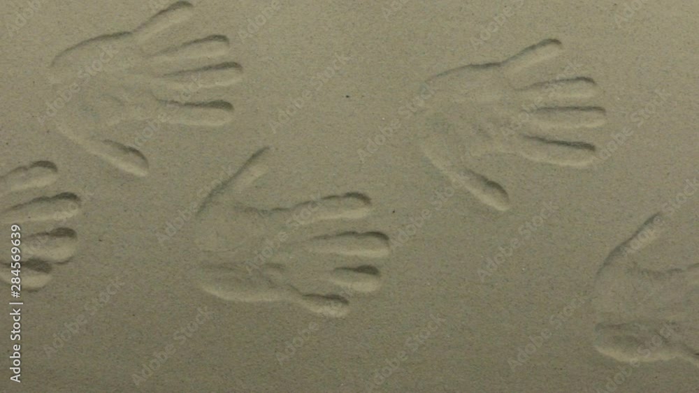Panorama, Imprints of human hands in the sand, lots of hand prints on the sand. Panorama, Imprints of human hands in the sand, lots of hand prints on the sand.