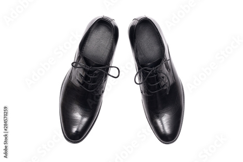Black leather shoes isolated on a white background.