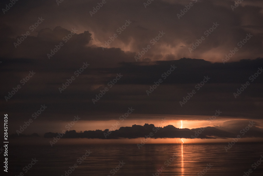 Beautiful summer storm over Black Sea - dramatic scenery, lightning strikes, fire in the sky Beautiful summer storm over Black Sea - dramatic scenery, lightning strikes, fire in the sky