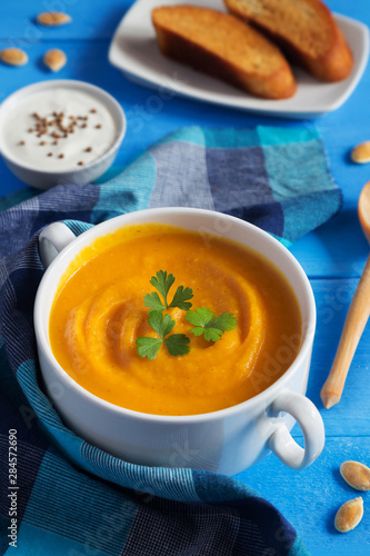 Pumpkin cream soup with seeds and parsley
