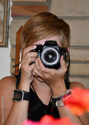 woman with digital single lens reflex camera