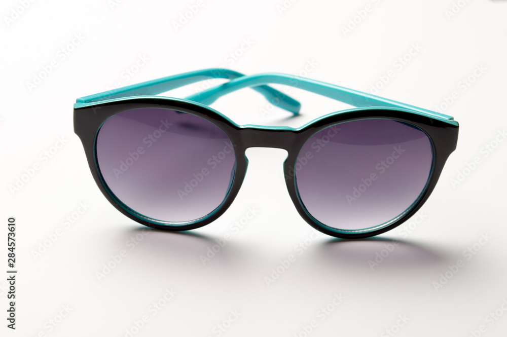 Stylish plastic dark sunglasses on colorful background. Eye care and diseases concept, eye protection. Stylish plastic dark sunglasses on colorful background. Eye care and diseases concept, eye protection.