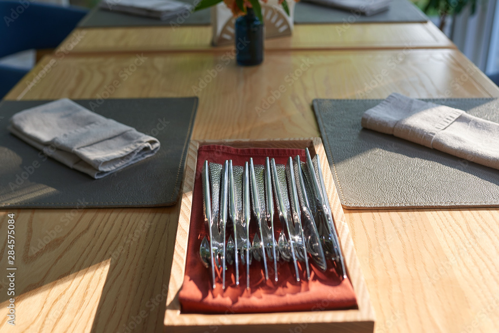 Cutlery on a wooden table in a restaurant Cutlery on a wooden table in a restaurant