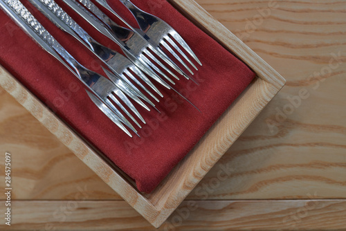 Cutlery on a wooden table in a restaurant