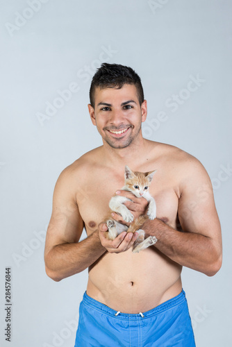 stduio shot of man and kitty smiling photo