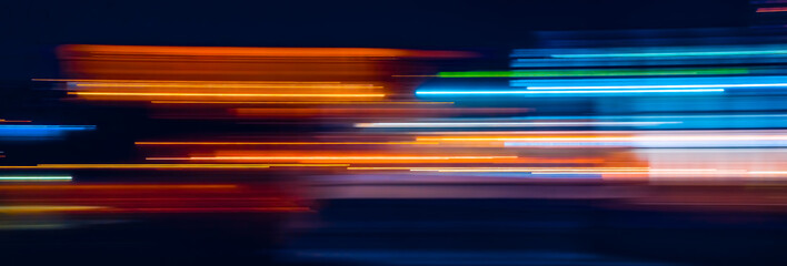Abstract Rainbow light trails on the dark background