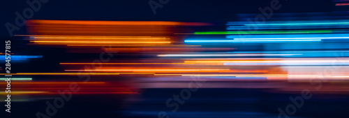 Abstract Rainbow light trails on the dark background photo