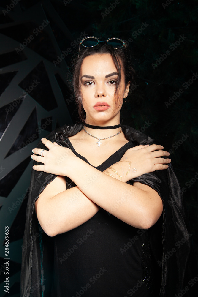 Beautiful goth fashion stylish girl on black studio background