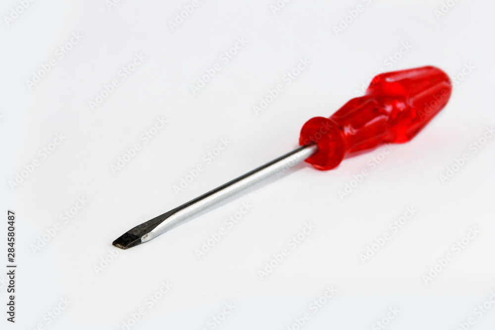 old rusty metal screwdriver for screws with red handle old rusty metal screwdriver for screws with red handle