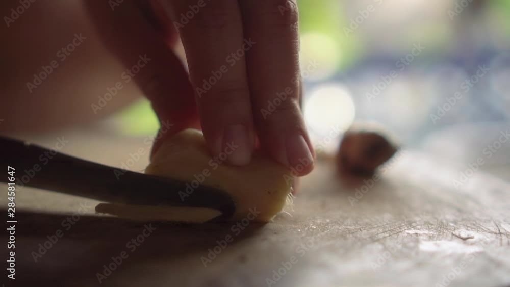 Lady chopping ginger to pieces on wooden board. Slow motion. Lady chopping ginger to pieces on wooden board. Slow motion.