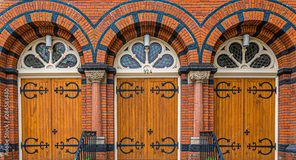 Fototapeta premium Three old wooden doors at Saint Andrews Presbyterian church in Victoria, British Columbia, Canada