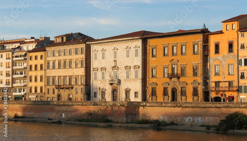 Colorful palazzo facades at Arno river in Pisa, Italy, on a sunny evening