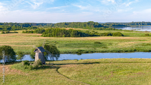 River in a green valley with a mill