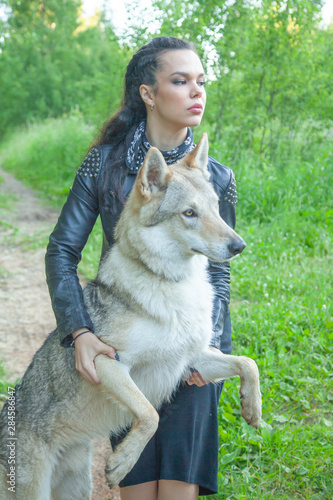 Adult pretty model girl with real mix animal of wolf and dog