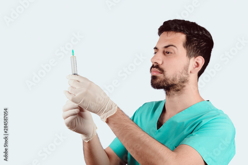 Doctor male holding syringe