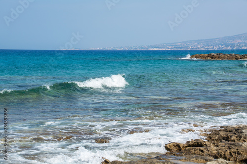 Fototapeta Naklejka Na Ścianę i Meble -  Seascape of the Mediterranean Sea with waves of the turquoise sea on the volcanic coast of Cyprus