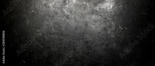 Rough, dark stone background lit by spotlight background