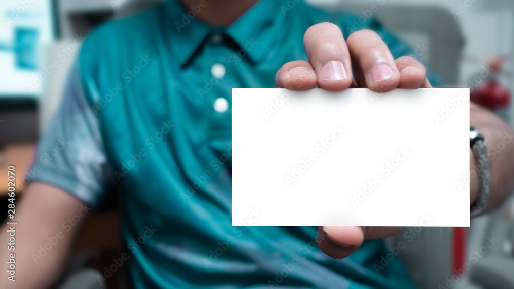 Man holding a blank white small card. -Template for business card or some other information. Man holding a blank white small card. -Template for business card or some other information.