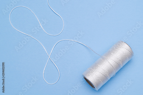 White nylon twine on blue.