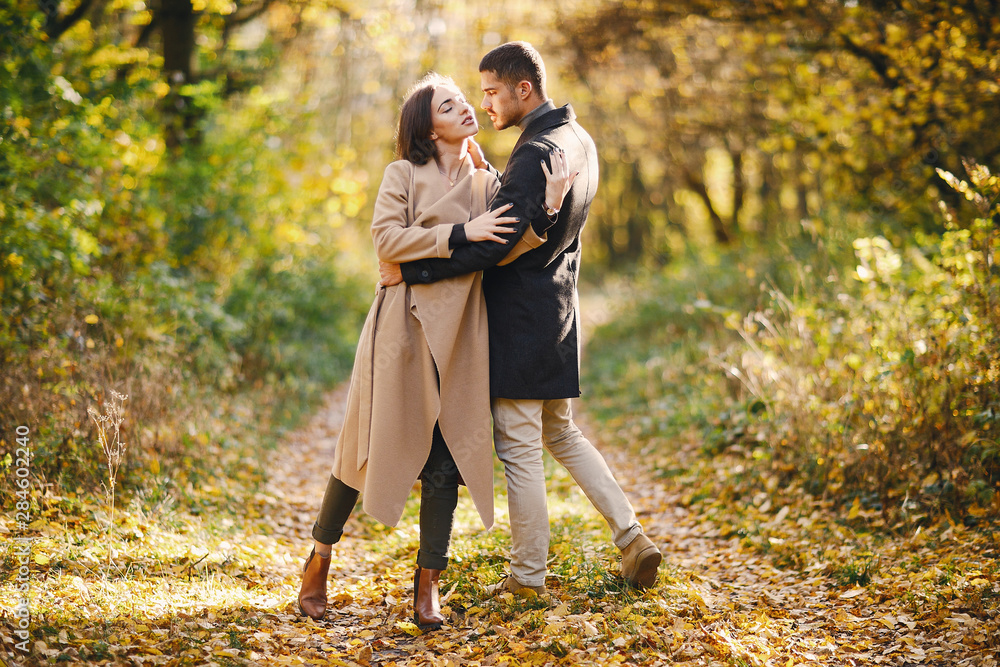 Fototapeta premium lovely couple walking around the park during autumn