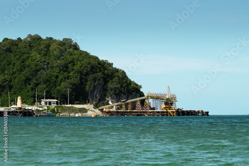 Outdoor industrial jetty with incline large conveyor for transportation.
