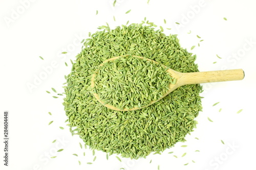 dried fennel seeds or Saunf herb in spoon isolated, top view 