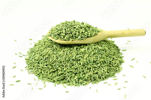 dried fennel seeds or Saunf herb in spoon isolated, top view  photo