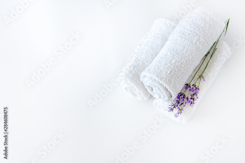 white clean towels and lavender flowers on white isolated background