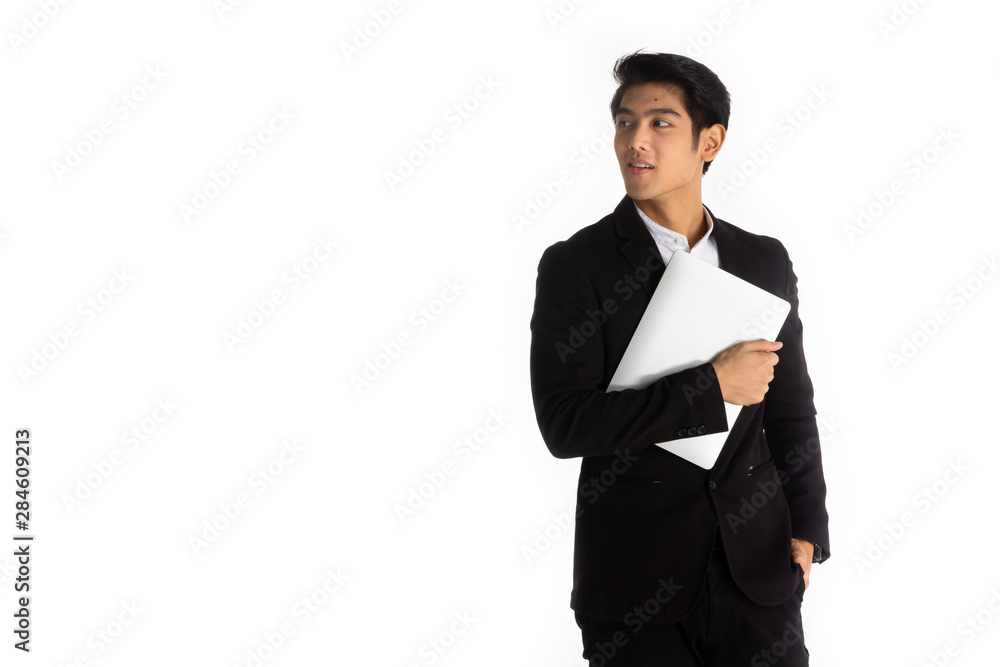 Handsome young businessman Asian caucasian wear a black suit with black hair, be a smile and standing smart poses. hold a computer laptop and use it. On a white background. Handsome young businessman Asian caucasian wear a black suit with black hair, be a smile and standing smart poses. hold a computer laptop and use it. On a white background.
